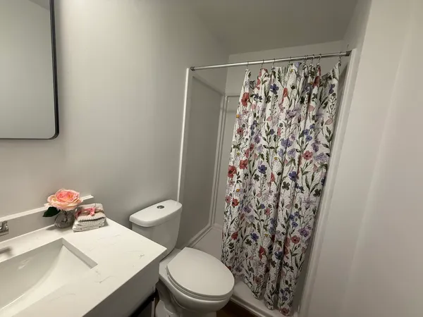 a white toilet sitting next to a bathroom sink