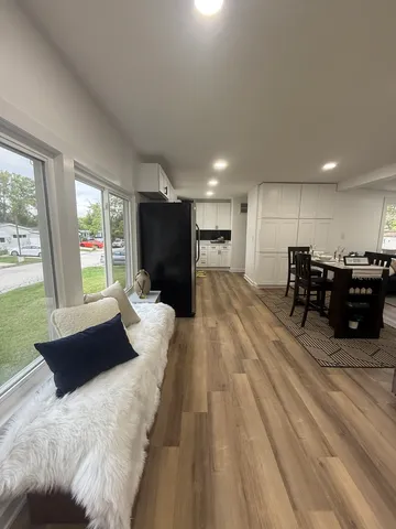a view of a closet area with wooden floor