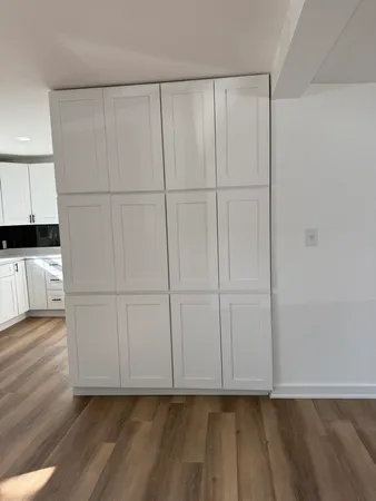 a view of a closet area with wooden floor