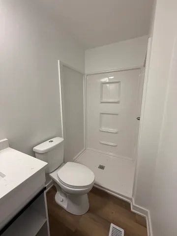 a white toilet sitting next to a bathroom sink
