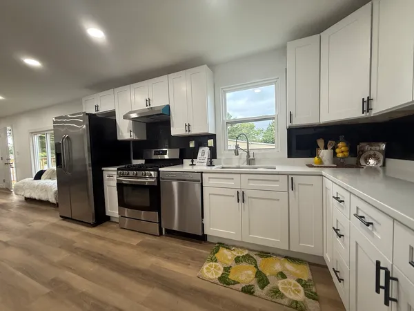 a kitchen with a sink cabinets and stainless steel appliances
