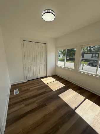 a view of a room with wooden floor and staircase