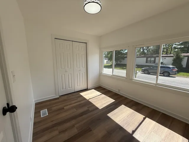 wooden floor in an empty room with a window