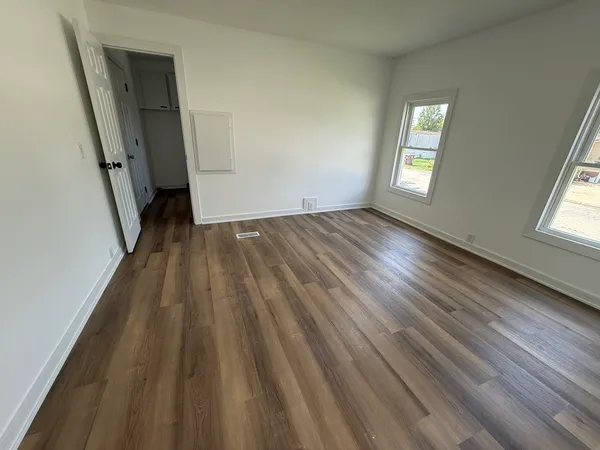 wooden floor in an empty room with a window
