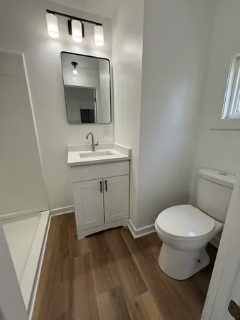 a bathroom with a toilet sink and mirror