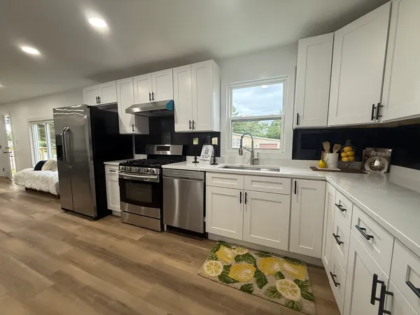 a kitchen with appliances cabinets and a sink