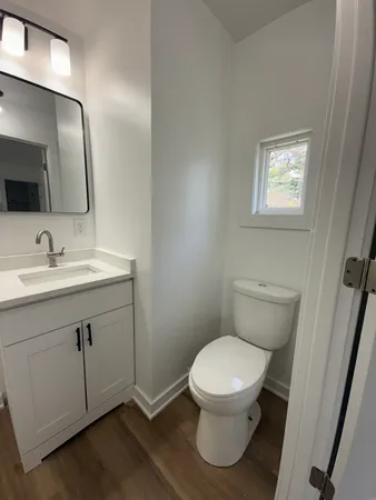 a bathroom with a toilet sink and mirror