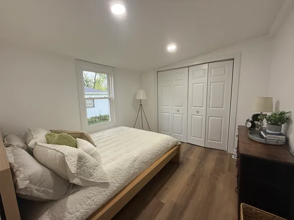 a bedroom with a bed and a window