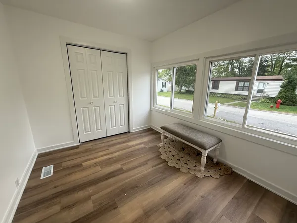 a room with wooden floor and furniture
