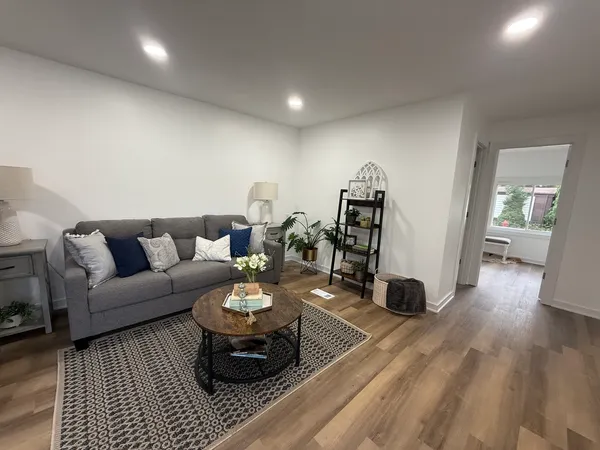 a living room with furniture and wooden floor