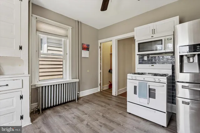 a kitchen with stainless steel appliances granite countertop a stove and a refrigerator