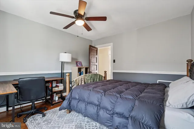 a bedroom with a bed a desk and chair