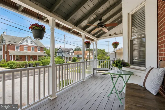 a view of a chairs and table in patio with wooden floor