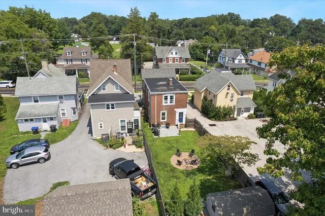 an aerial view of a house with a garden and trees