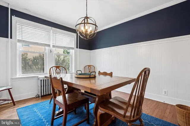 a view of a dining room with furniture wooden floor and chandelier