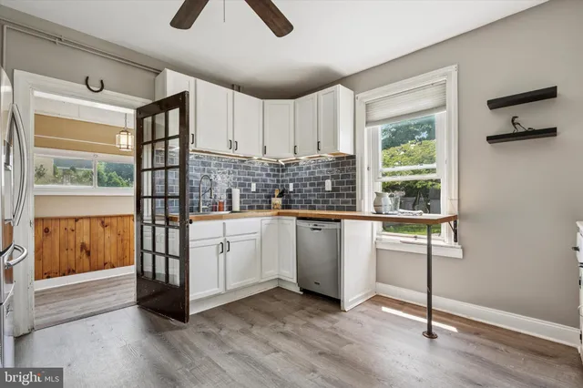 a kitchen with sink cabinets and wooden floor
