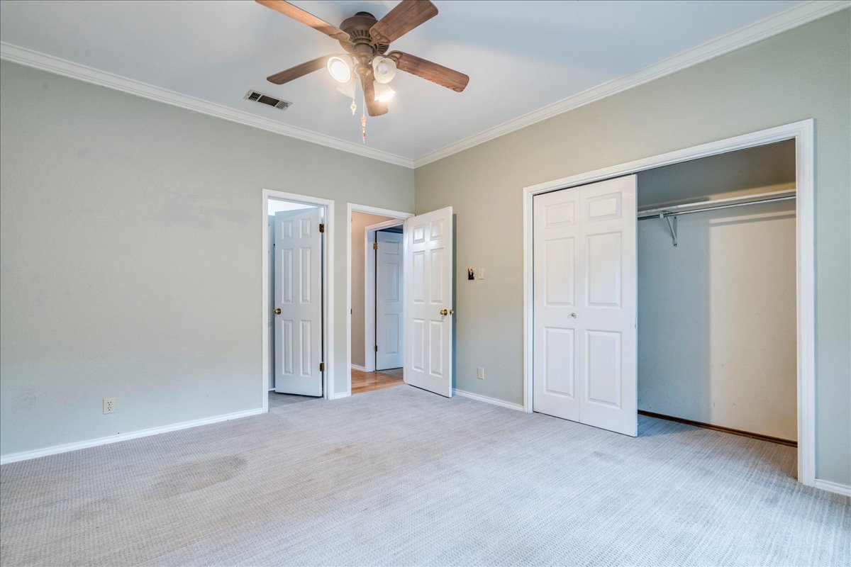 3809 Spicewood Springs Road, Unit 127 Austin, TX 78759 - Photo 18 of 29 A comfortable bedroom with carpeted flooring and a convenient ceiling fan.