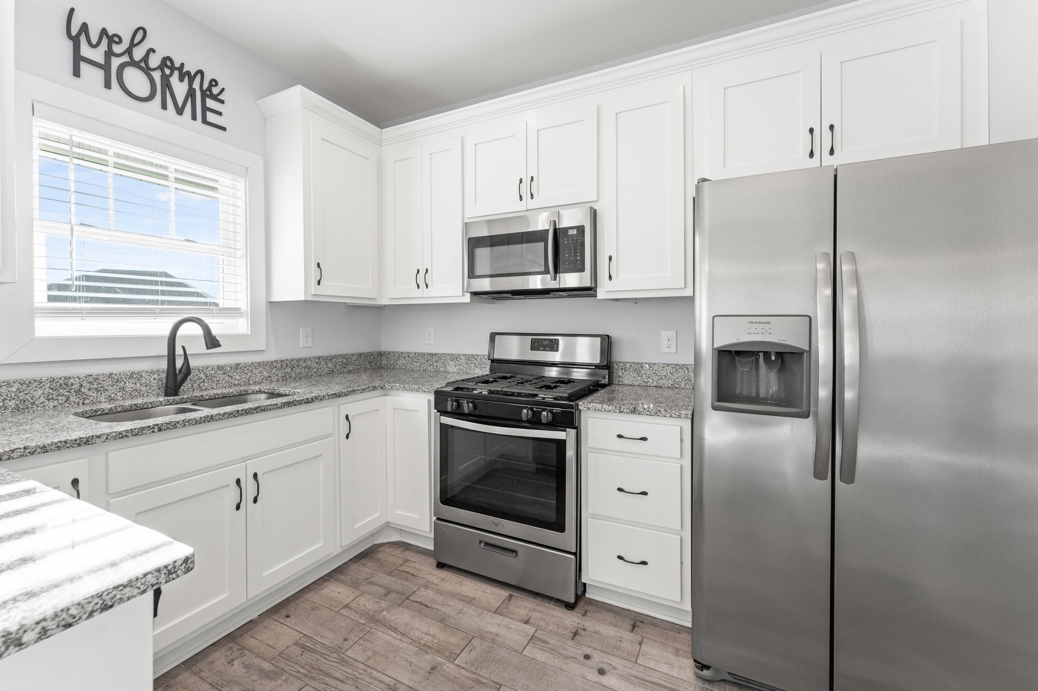 1295 Old Estill Springs Road Winchester, TN 37398 - Photo 11 of 34 a kitchen with stainless steel appliances granite countertop a refrigerator sink and stove