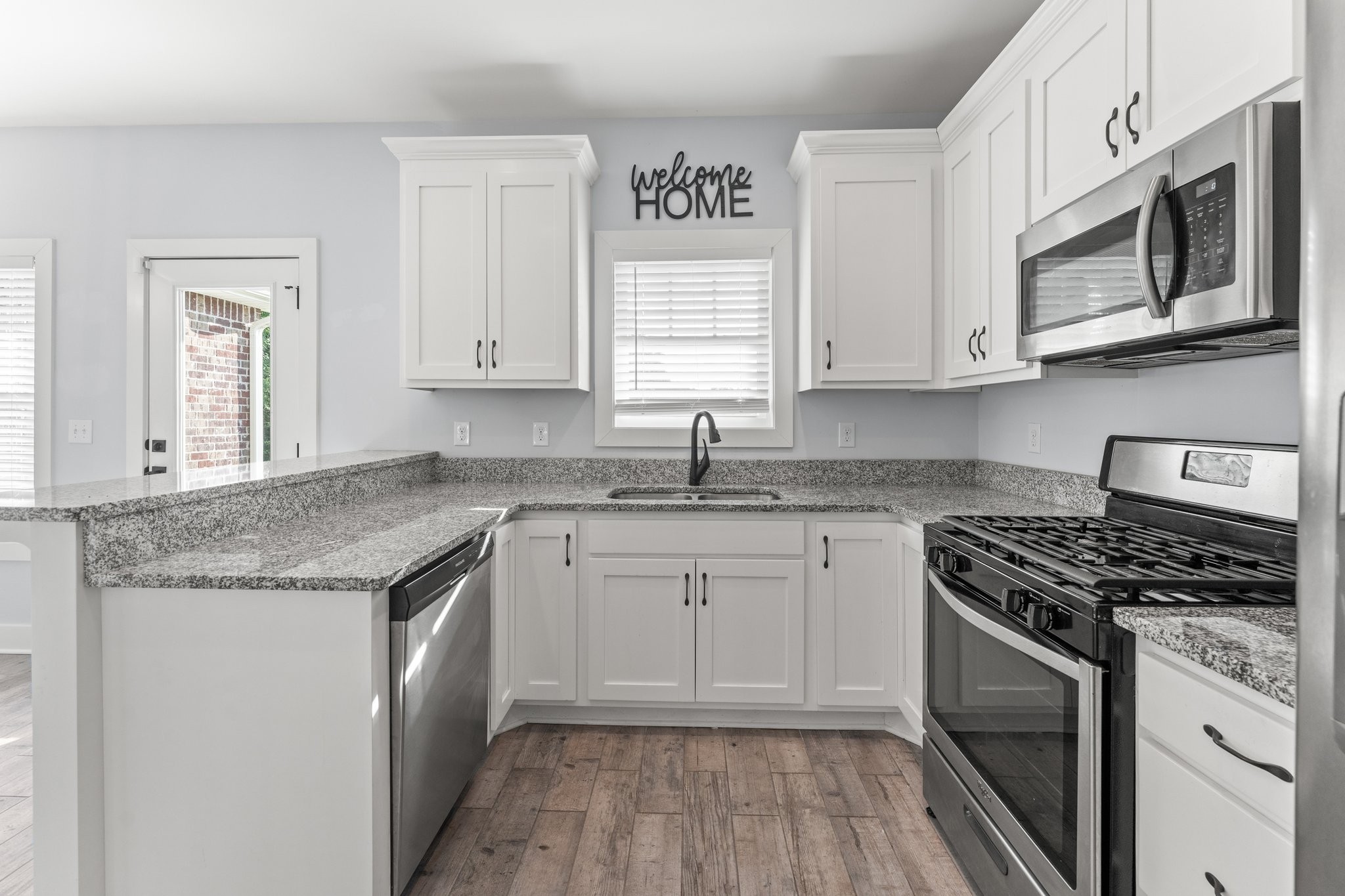 1295 Old Estill Springs Road Winchester, TN 37398 - Photo 12 of 34 a kitchen with granite countertop cabinets stainless steel appliances and a sink