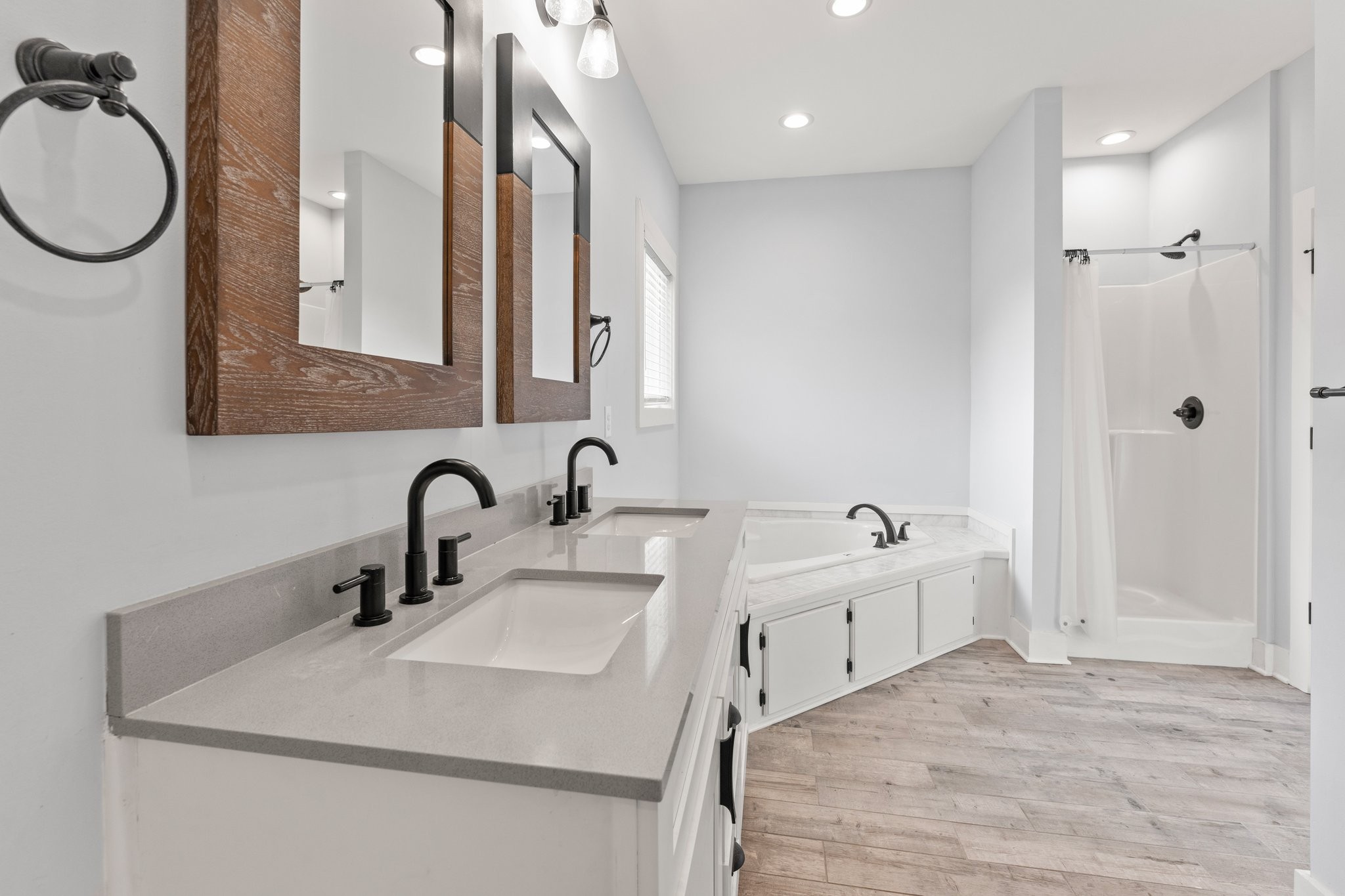 1295 Old Estill Springs Road Winchester, TN 37398 - Photo 18 of 34 a bathroom with a double vanity sink a mirror and a bathtub
