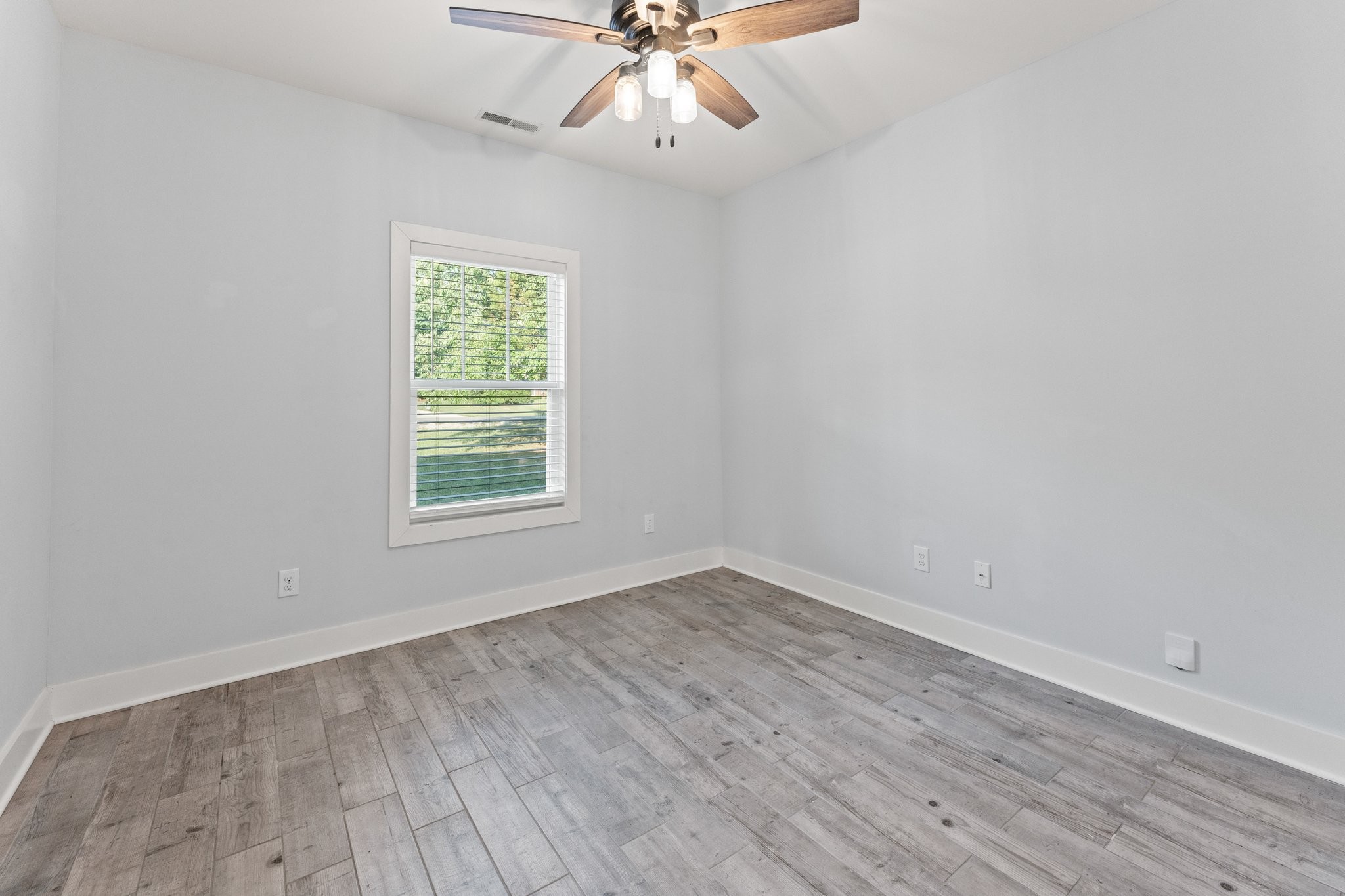 1295 Old Estill Springs Road Winchester, TN 37398 - Photo 24 of 34 wooden floor in an empty room with a window