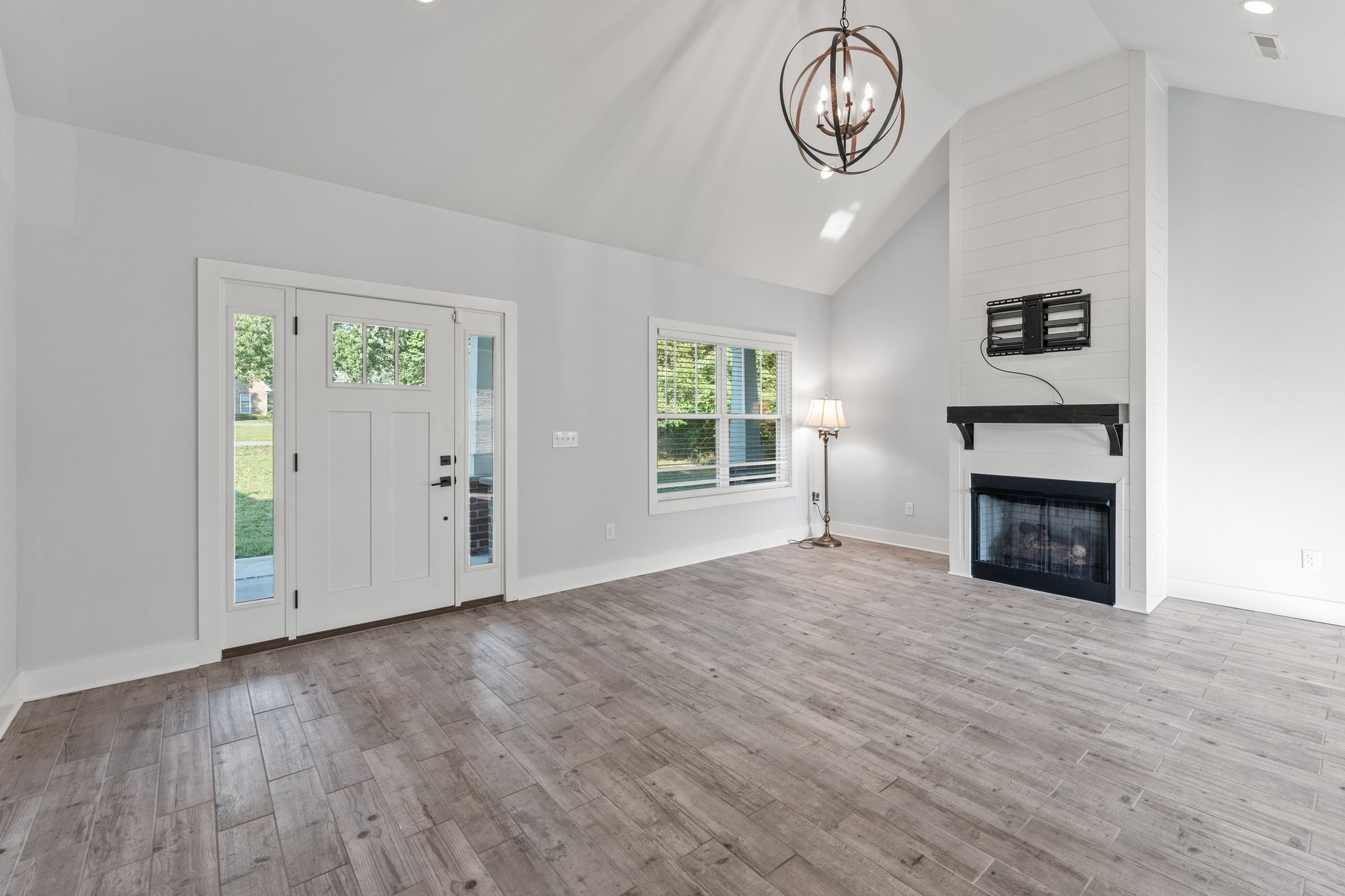 1295 Old Estill Springs Road Winchester, TN 37398 - Photo 6 of 34 an empty room with windows and fireplace