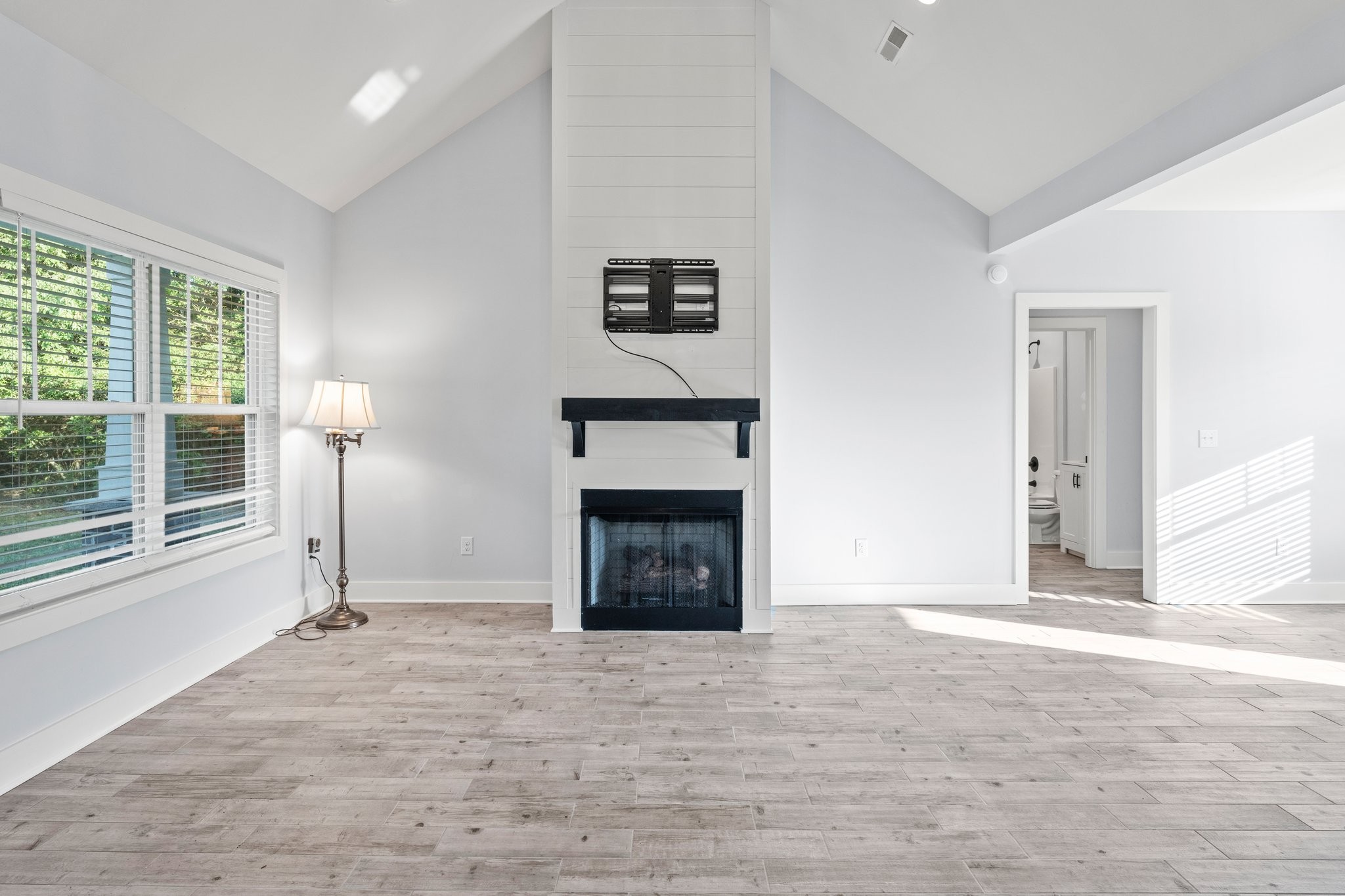 1295 Old Estill Springs Road Winchester, TN 37398 - Photo 7 of 34 a view of an empty room with a fireplace and a window
