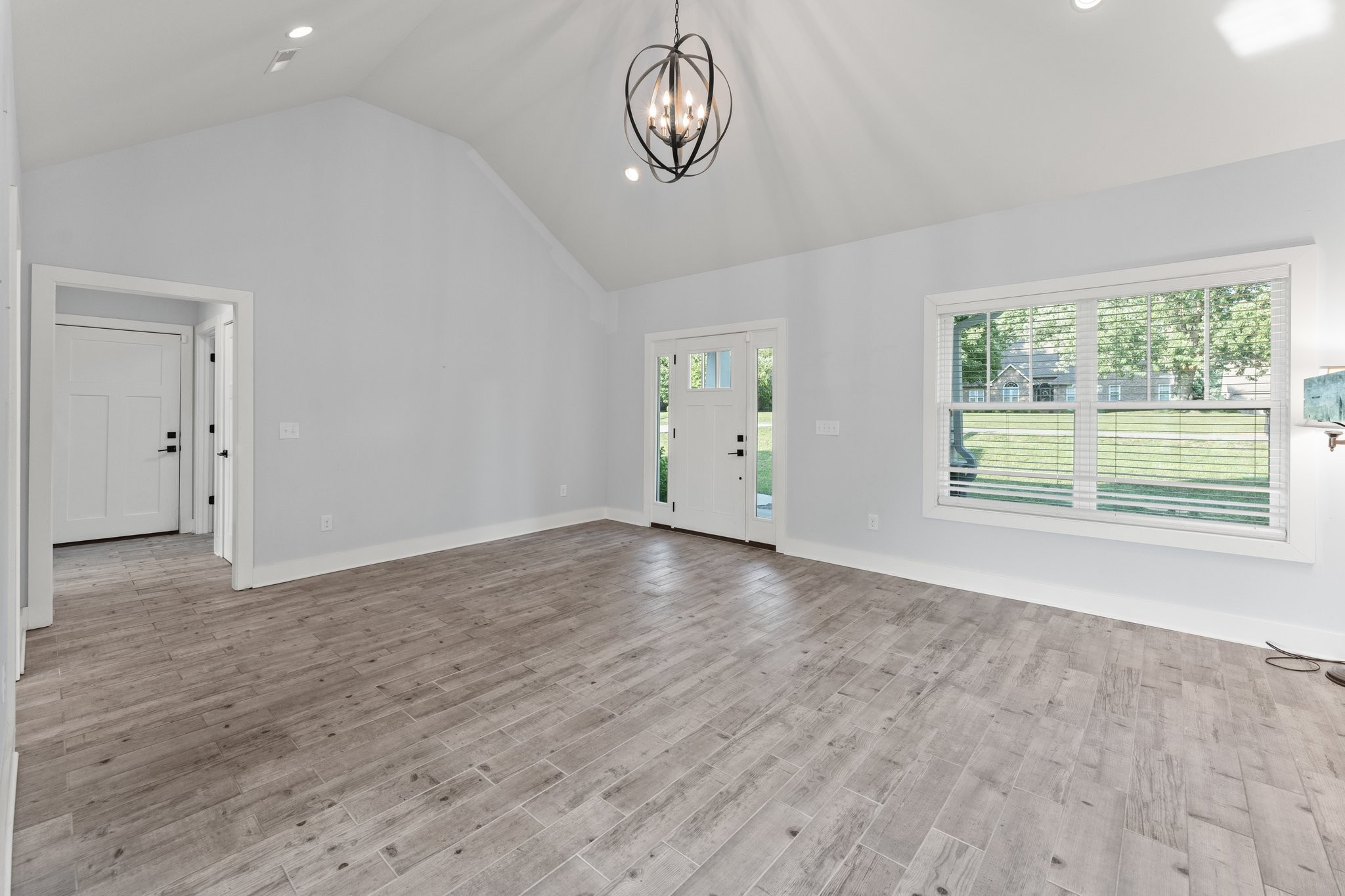 1295 Old Estill Springs Road Winchester, TN 37398 - Photo 8 of 34 an empty room with wooden floor and windows