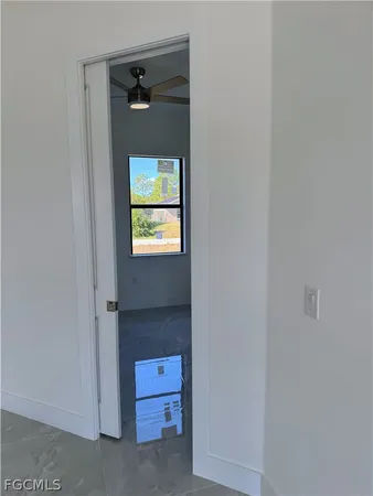 en empty room with window and fan