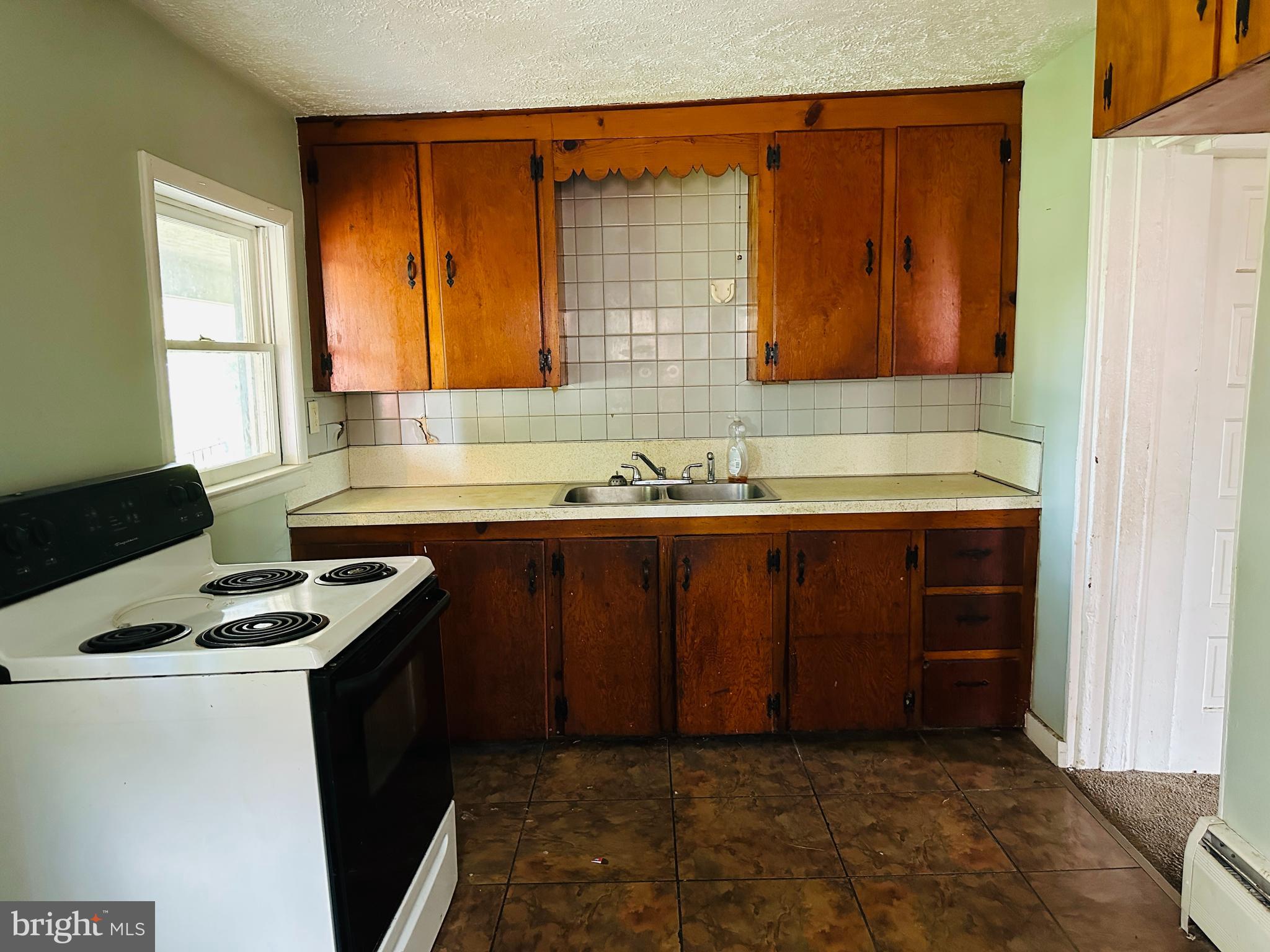 3666 Orrstown Road Orrstown, PA 17244 - Photo 5 of 11 a kitchen with a sink a stove cabinets and a window