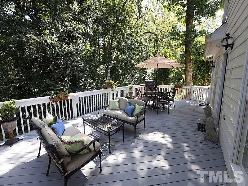 2805 Rothgeb Drive Raleigh, NC 27609 - Photo 2 of 25 a view of a patio with table and chairs under an umbrella with wooden floor