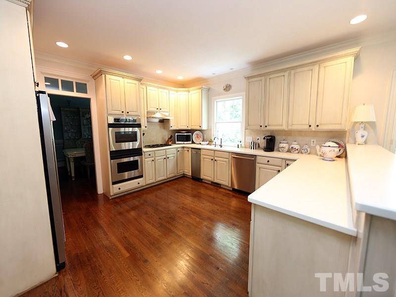 2805 Rothgeb Drive Raleigh, NC 27609 - Photo 12 of 25 a kitchen with stainless steel appliances a sink a stove a refrigerator and cabinets
