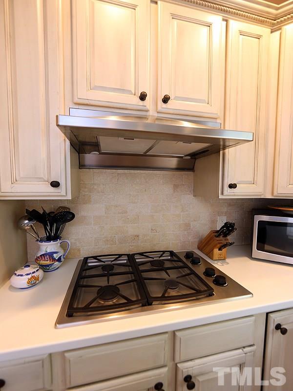 2805 Rothgeb Drive Raleigh, NC 27609 - Photo 13 of 25 a stove top oven sitting inside of a kitchen