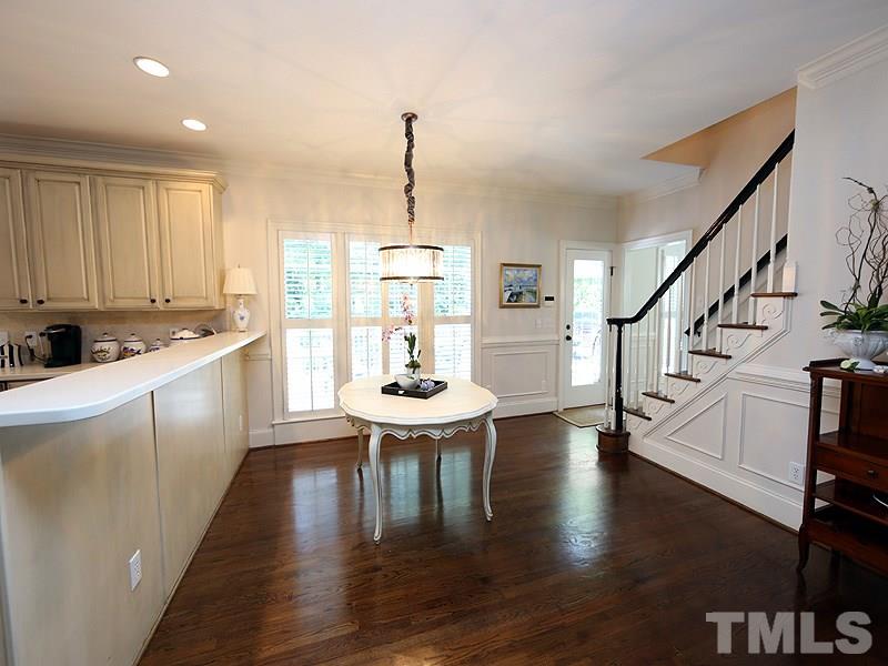 2805 Rothgeb Drive Raleigh, NC 27609 - Photo 14 of 25 a kitchen with stainless steel appliances kitchen island granite countertop a stove a sink and a refrigerator