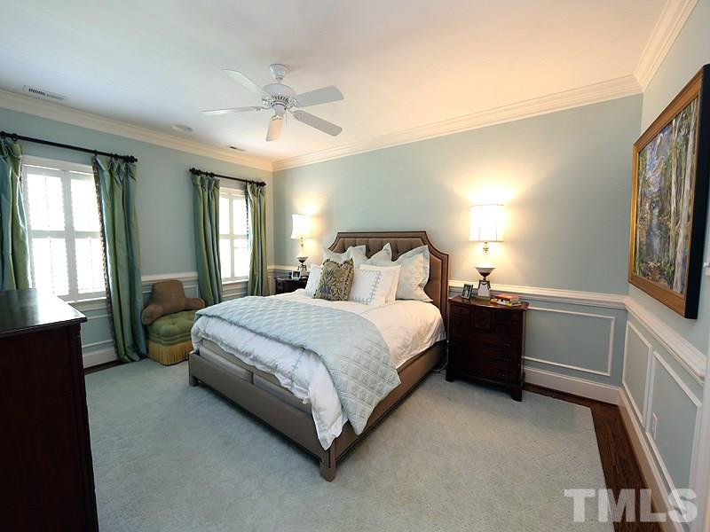 2805 Rothgeb Drive Raleigh, NC 27609 - Photo 17 of 25 a spacious bedroom with a bed and a chandelier