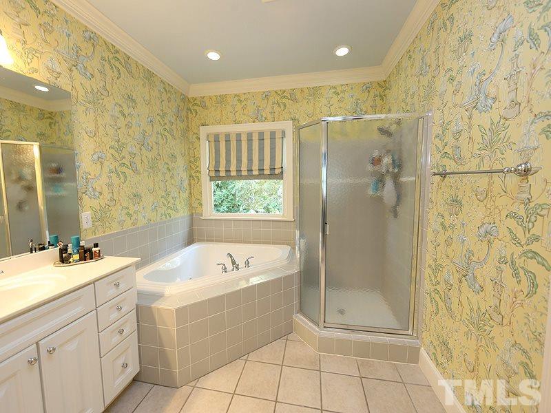 2805 Rothgeb Drive Raleigh, NC 27609 - Photo 18 of 25 a bathroom with a tub sink shower and mirror