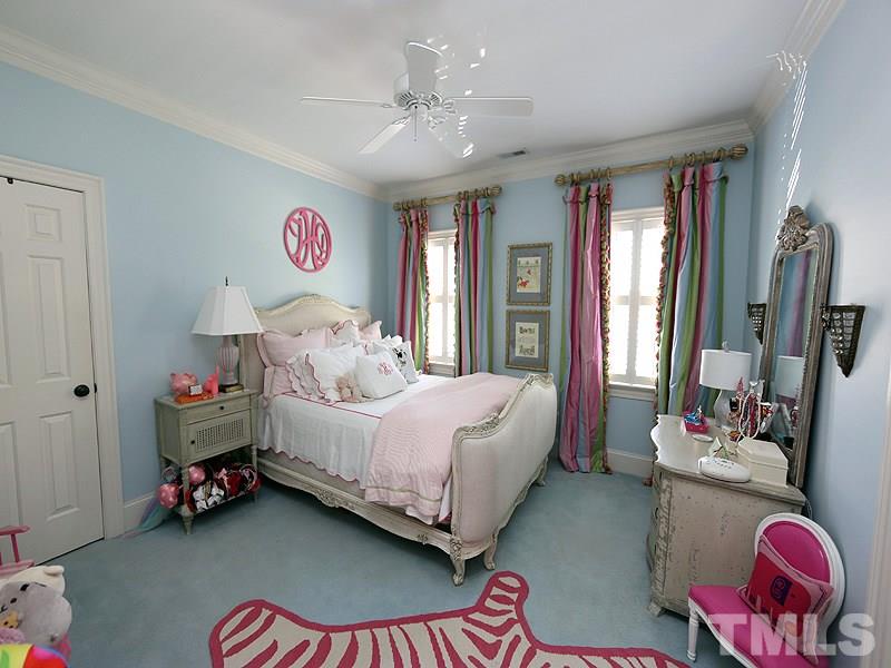 2805 Rothgeb Drive Raleigh, NC 27609 - Photo 19 of 25 a bedroom with a bed and a chandelier