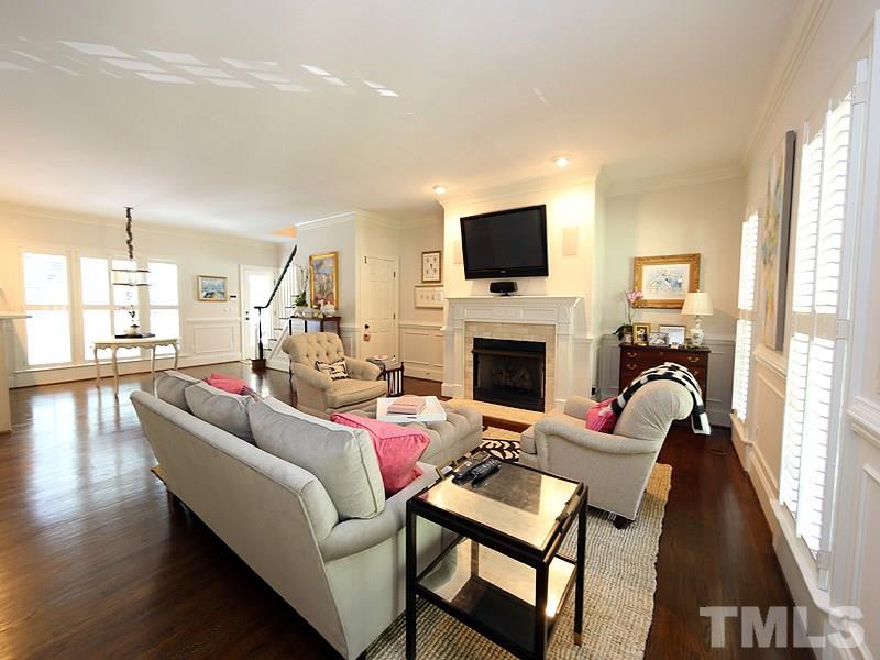 2805 Rothgeb Drive Raleigh, NC 27609 - Photo 3 of 25 a living room with furniture a fireplace and a flat screen tv