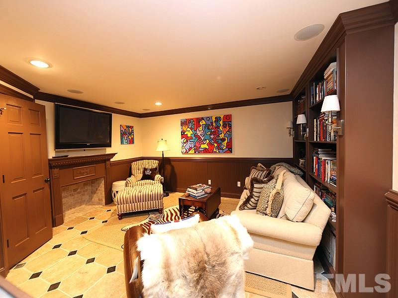 2805 Rothgeb Drive Raleigh, NC 27609 - Photo 4 of 25 a living room with furniture gym equipment and a flat screen tv