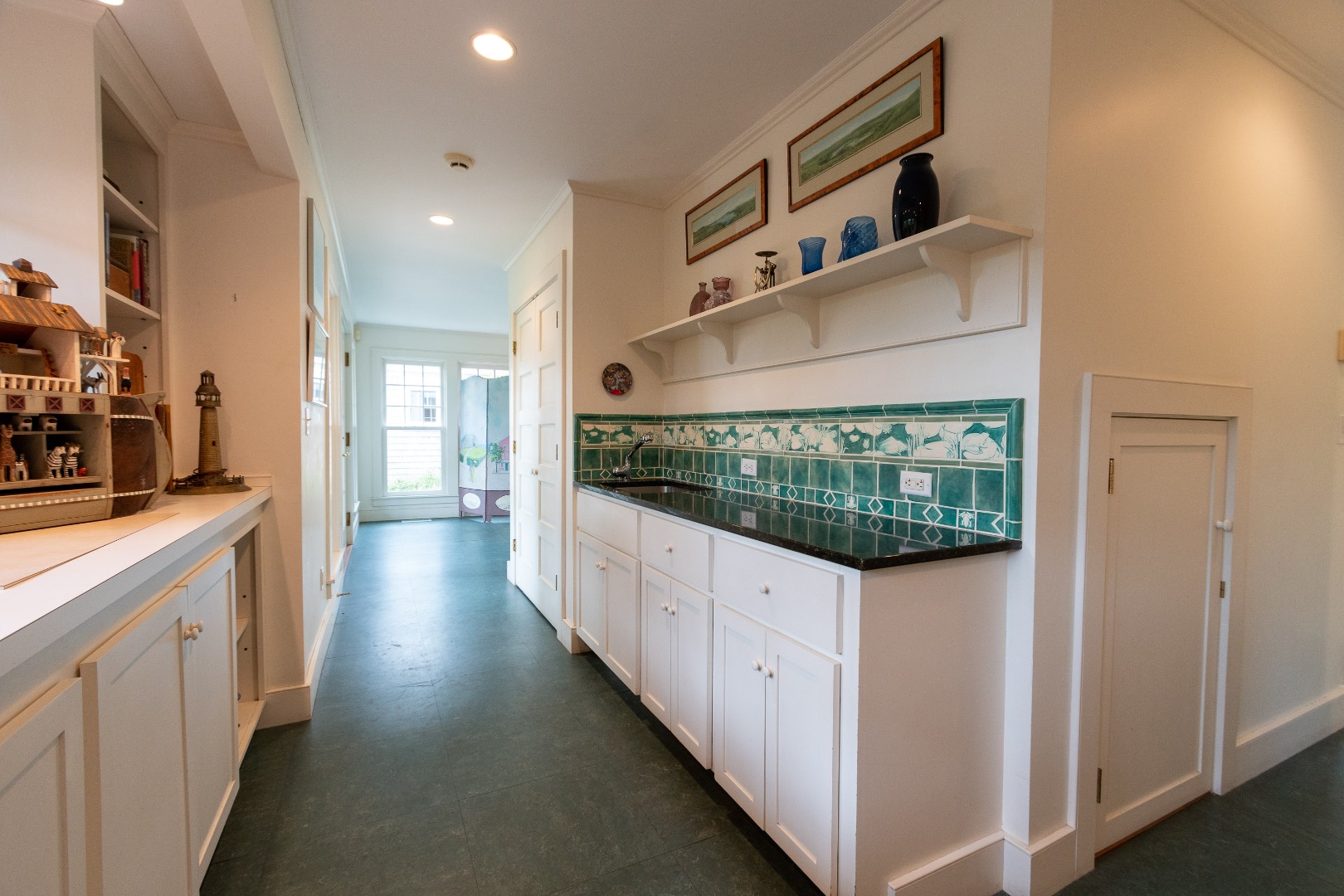 15 Cliff Road Nantucket, MA 02554 - Photo 23 of 50 a kitchen with white cabinets and window