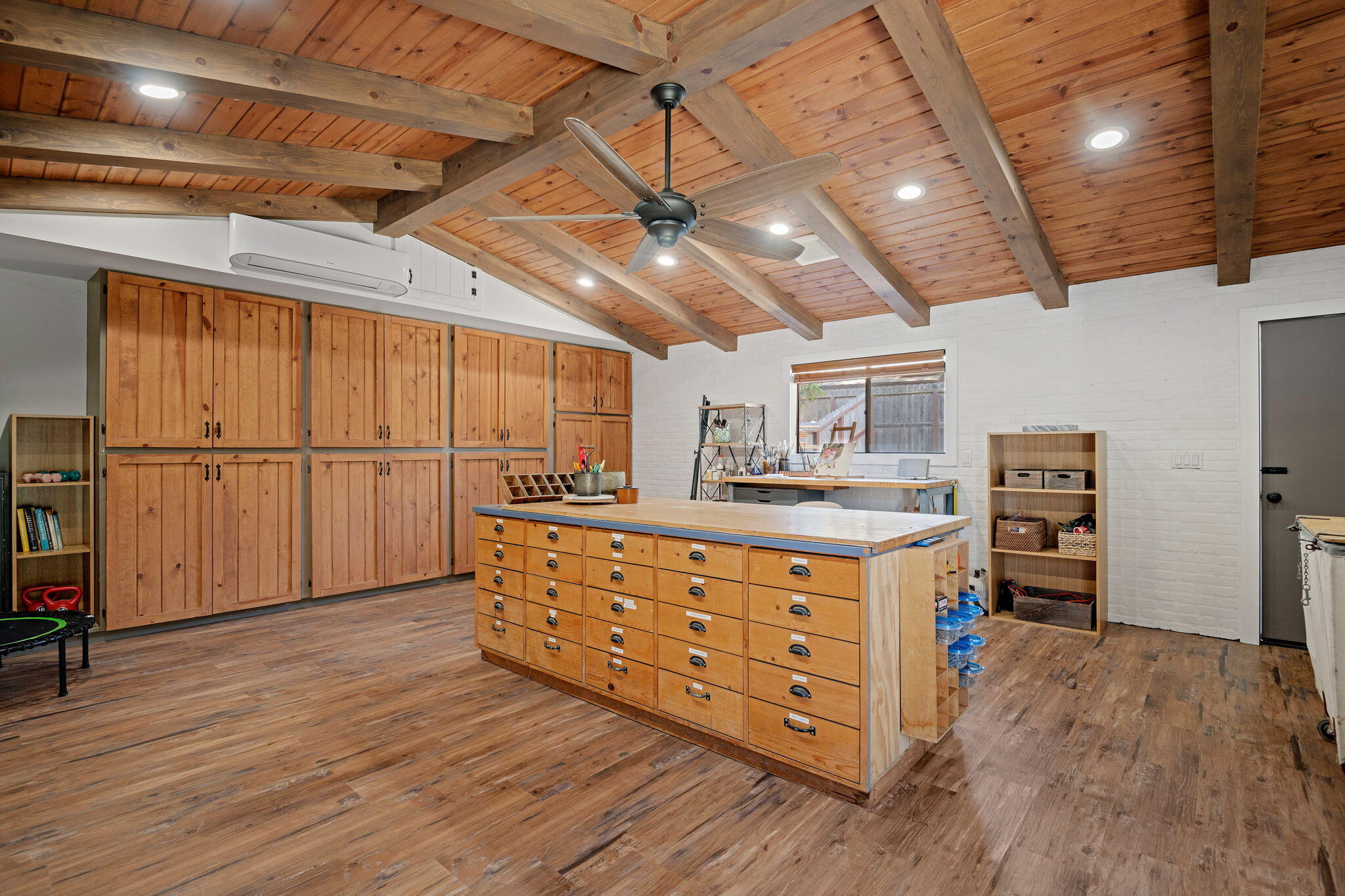 793 Alisal Road Solvang, CA 93463 - Photo 39 of 44 a room with wooden cabinets and furniture
