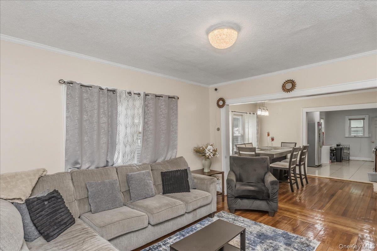 237 Rhodes Avenue Hempstead, NY 11550 - Photo 6 of 24 a living room with furniture and wooden floor
