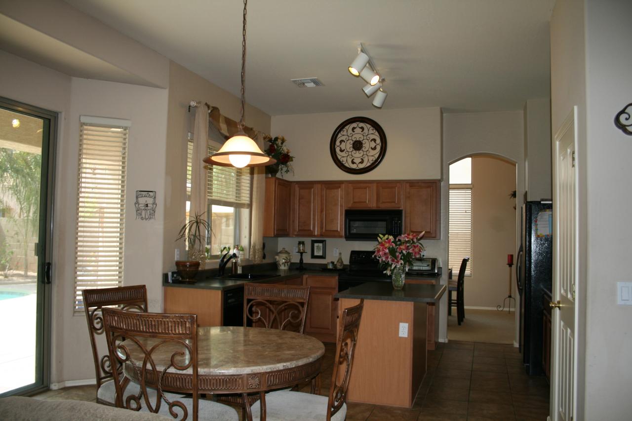 4642 South Calico Road Gilbert, AZ 85297 - Photo 4 of 20 a dining room with furniture and chandelier