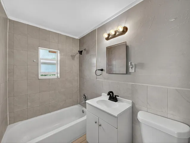 a bathroom with a sink a toilet and a bathtub