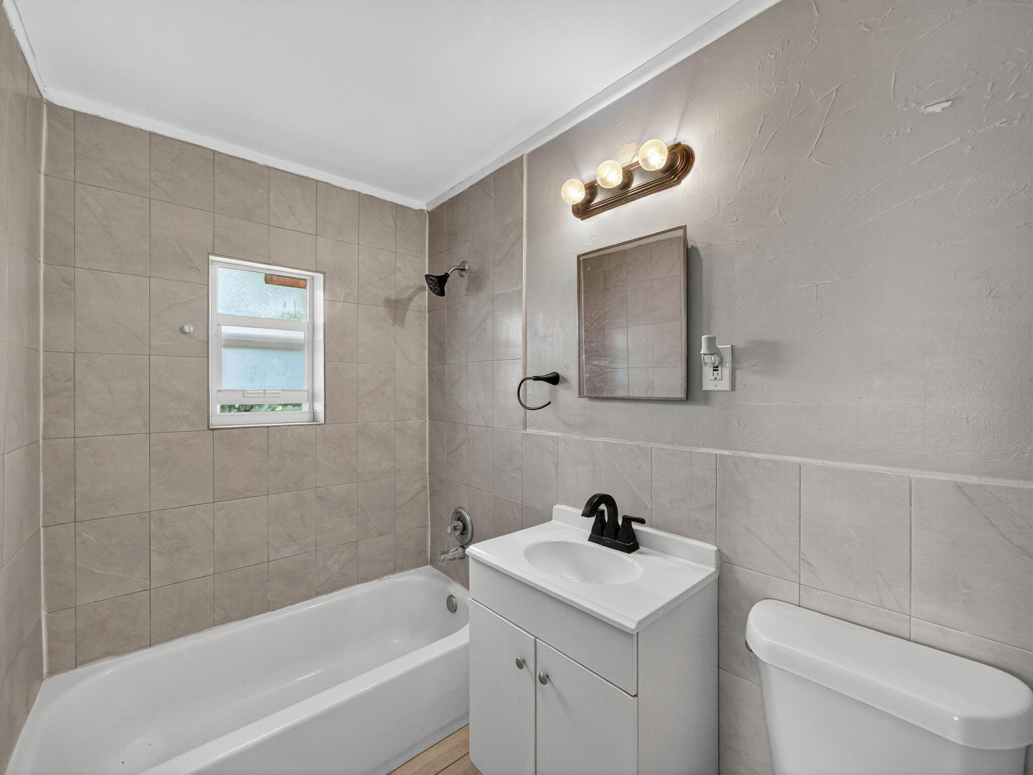 1373 West 35th Street Riviera Beach, FL 33404 - Photo 16 of 20 a bathroom with a sink a toilet and a bathtub