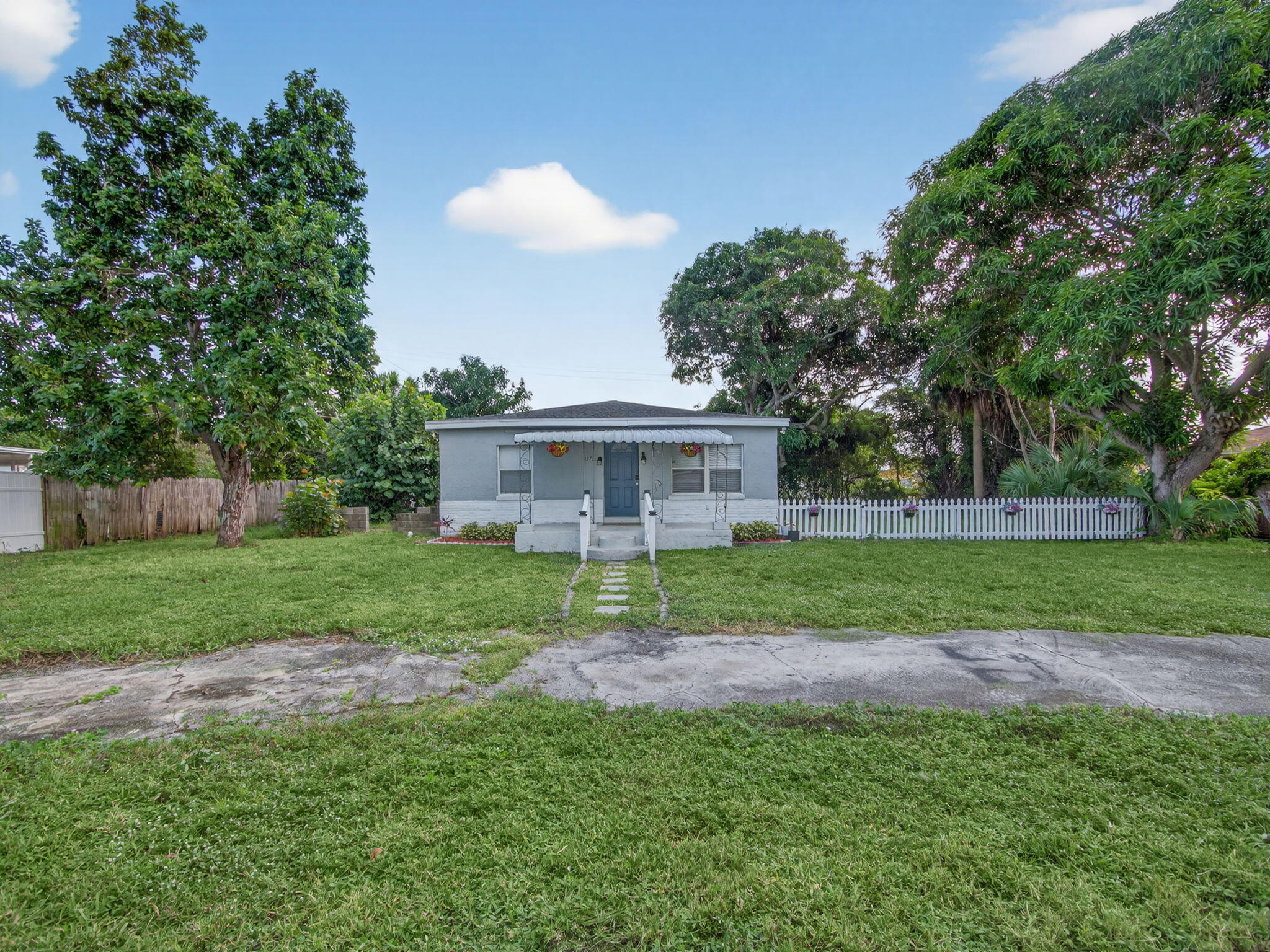 1373 West 35th Street Riviera Beach, FL 33404 - Photo 3 of 20 a view of a house with a yard