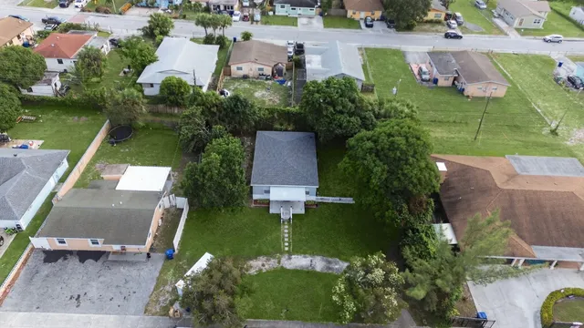 an aerial view of a house with garden space and street view