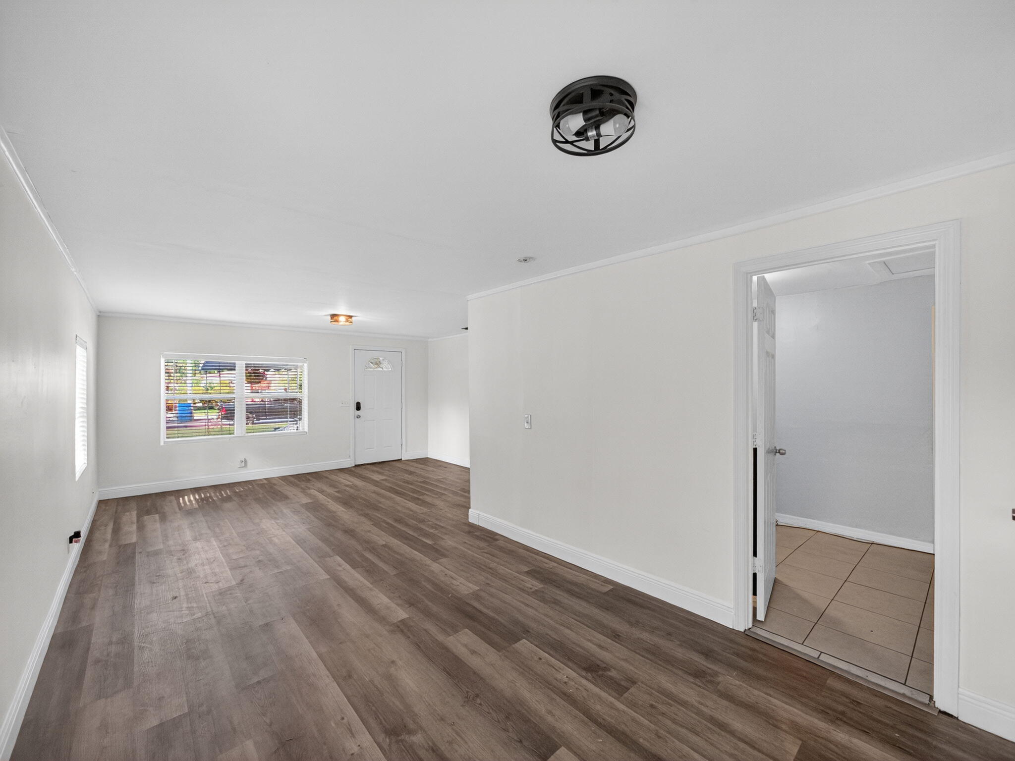 1373 West 35th Street Riviera Beach, FL 33404 - Photo 8 of 20 an empty room with wooden floor and windows