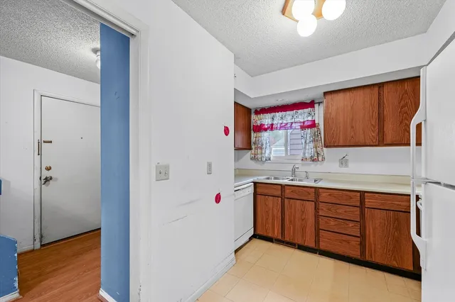 a utility room with cabinets washer and dryer