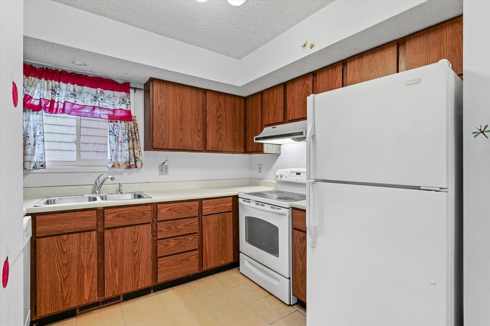 1928 Blackthorn Drive, Unit 1 Champaign, IL 61821 - Photo 12 of 28 a kitchen with stainless steel appliances a refrigerator sink and cabinets